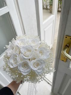 a bouquet of white flowers sitting in front of a door