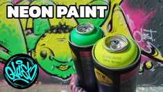 two cans of neon paint sitting next to each other