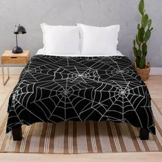 a black and white spider web pattern on a bed