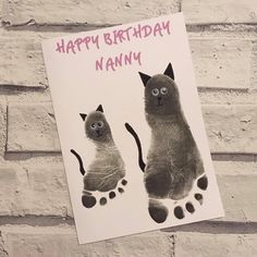 a happy birthday card with an image of a cat and its paw print on it