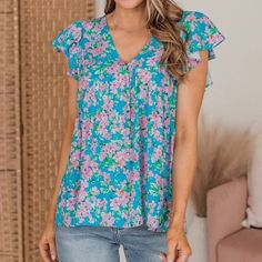 So Feminine And Flirty- We Are Loving This! The For A Moment Women’s Boutique Printed Babydoll Top Features A Deep V-Neckline, Flutter Sleeves, Empire Waist, And A Flared Bottom Hem. The Multicolored Floral Print Has The Perfect Mix Of Blues, Pinks, And Greens! Fit Details: Fitted In The Bust With No Stretch. V-Neckline With Empire Waist Ruffle Cap Sleeves Size Medium Medium: Bust 36“ Length 24“ New Women’s Boutique Clothing Brand: Emily Wonder Retail Price: $48-$52 Fast Shipping! Bundle & Save! Summer Pink Flutter Sleeve Tops, Pink Butterfly Sleeve Top For Spring, Light Blue Floral Print V-neck Top, Cute V-neck Tops For Vacation, Pink Flutter Sleeve Tops For The Beach, Pink Flutter Sleeve Top For Beach, Blue Floral Print Top With Flutter Sleeves, Blue Flutter Sleeve Tops With Floral Print, Blue Floral Print Tops With Flutter Sleeves