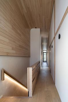 the hallway is lined with wood and white walls