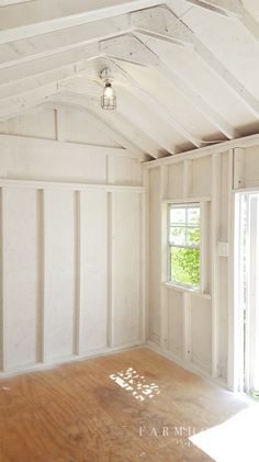 an empty room with wooden floors and white walls, in the process of being renovated