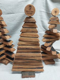 three small wooden christmas trees are stacked on top of each other