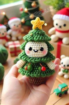 someone is holding up a tiny crocheted christmas tree