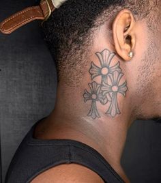 a man with a cross tattoo on his neck and behind the ear is a brown leather belt