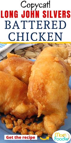 a blue plate topped with fried chicken on top of a table