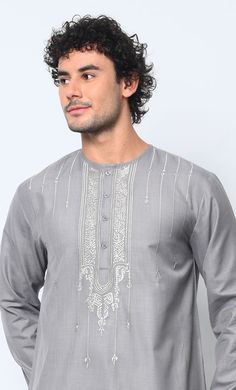 Introducing our distinguished Men's Thobe adorned with exquisite Islamic ornament embroidery on the front chest, meticulously crafted to embody the essence of tradition and style. This exceptional garment seamlessly blends cultural heritage with contemporary sophistication, making it a standout choice for any occasion. Featuring Front button down placket from neck to chest, Straight sleeves and Dual Pockets. This Thobe offers both functionality and style. Perfectly positioned for convenience, these pockets provide ample space for storing essentials while maintaining the sleek silhouette of the garment. Crafted from premium quality fabric, our Men's Thobe ensures unparalleled comfort and durability, allowing you to move with ease while exuding confidence and grace. Whether worn for religiou Short Kurtas, Islamic Ornament, Ornament Embroidery, Cultural Heritage, Kurti Designs, Quality Fabric, Premium Quality, Essence, Sleek