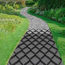 an image of a path in the middle of a field with grass and bushes on both sides