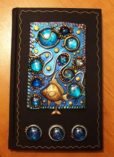 a book with buttons on it sitting on top of a wooden table