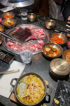 a table topped with lots of different types of food and utensils on top of it