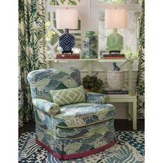 a living room with green and blue decor on the walls, furniture and rugs