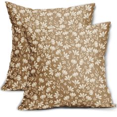 two brown pillows with white flowers on them