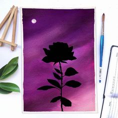 a painting of a flower on a purple background next to paintbrushes and watercolor pencils