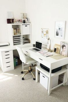 a white desk topped with a laptop computer sitting next to a drawer filled with drawers