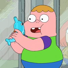 a cartoon character holding a blue object in his right hand and looking at the camera