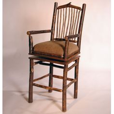 a wooden chair with a brown cushion on top of it's armrests