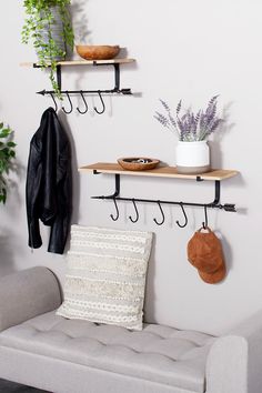 three shelves with hooks and hats on them