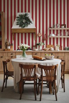 a dining room with red and white striped walls