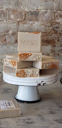 cream colored handmade bar soap with oats and honeycomb look stacked on vintage metal pedestal with old brick wall background Soap Wallpaper, Soap Pictures, Honey Fragrance, Soap Stand, Soap Scrub, Lye Soap, Unique Soap, Honey Soap, Luxury Soap