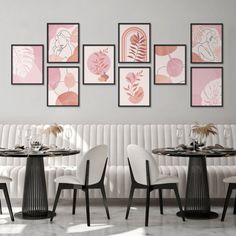 a dining room with white chairs and tables in front of pictures on the wall above them