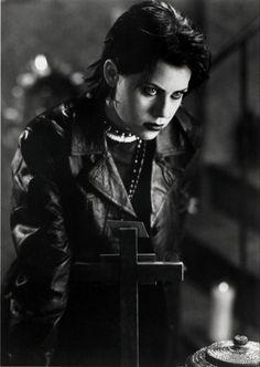 a black and white photo of a woman wearing a leather jacket