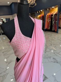 TO ORDER LARGER SIZES, PLEASE WHATSAPP +1 (945) 444-2194 Barbie Pink Ready saree accentuated with stone work border. Crafted halter neck blouse with v neck and stone detailing. paired with a classy skirt and attached pleats Slight variation in color is possible due to digital photography. Shipping will take 2 weeks,Please WHATSAPP +1 (945) 444-2194 for more info. Halter Neck Blouse Saree, Halter Saree Blouse, Halter Neck Saree Blouse, Halter Neck Saree, Ready Saree, Trending Saree, Halter Neck Blouse, Indian Dress Up