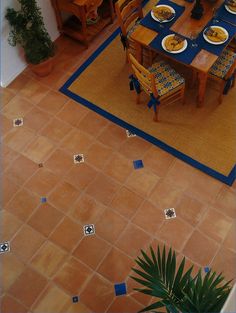 an overhead view of a dining room table and chairs with plates on the placemats