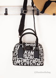 Style: Marc Jacobs Small Monogram Printed Dome Satchel Crossbody Bag Material: Saffiano Leather Features: Adjustable/Detachable Crossbody Strap, Fabric Lined, Inner Zip Pocket, Zip Closure Measures: 10" L x 7.5" H x 4.25" D Black Monogram Print Shoulder Bag, Chic Daily Use Bags With Monogram Print, Monogram Print Crossbody Bags For Travel, Chic Shopping Bag With Monogram Print, Chic Monogram Print Shopping Bag, Modern Leather Bag With Monogram Print, Logo Crossbody Satchel For Travel, Monogram Prints, Monogrammed Leather