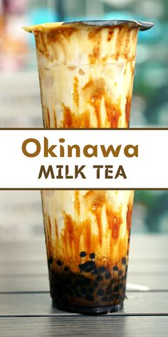 a drink in a glass with the words okinawa milk tea written on it