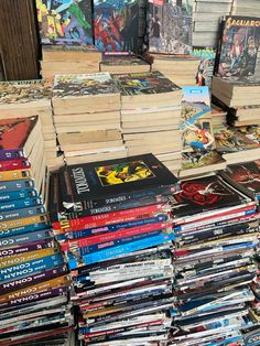 a pile of comic books sitting on top of a table