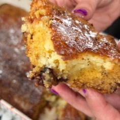 a close up of a person holding a piece of cake