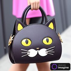 a close up of a handbag with a cat face on it