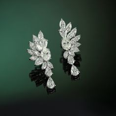 Whenever I visit Amsterdam, the first place I go to is the beautiful and timeless flower markets. I am immediately calmed by the striking display of flowers, bountiful and bursting with life. This is the feeling that I wanted to capture in the design of the Amsterdam Earrings. Delicately crafted with a combination of marquise, oval, and pear diamonds the diamond petals create a stunning structured edge, highlighting the grace and beauty only the Amsterdam Earrings can capture. Elegant Marquise Diamond Cut Cluster Earrings, Luxury Pear-shaped Cluster Earrings For Formal Occasions, Luxury Pear-shaped Cluster Earrings For Formal Events, Elegant Pear-shaped Cluster Earrings For Formal Occasions, Luxury Flower Shaped Diamond Wedding Earrings, Luxury Diamond White Cluster Earrings For Wedding, Elegant Platinum Brilliant Cut Cluster Earrings, Elegant Platinum Cluster Earrings With Brilliant Cut, Luxury Brilliant Cut Cluster Earrings