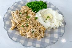 a plate with meat, mashed potatoes and peas