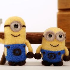 two small yellow and blue minion dolls sitting next to each other