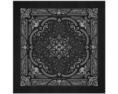 a black and white bandanna with skulls on it's sides, in an ornate design