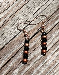 Black and copper glass bead earrings. Beads drop 1/2 in from the metal. Very simple and minimalistic jewelry. The metal is hypoallergenic. Cheap Brown Dangling Beads Earrings, Minimalistic Jewelry, Beaded Ankle Bracelets, Earrings Beads, Beautiful Anklet, Beaded Ankle, Glass Bead Earrings, Copper Glass, Leather Keyring