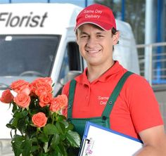 a man holding a bouquet of roses in front of a delivery truck with the company's logo on it