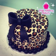 a leopard print cake with a black bow on top