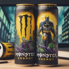 two cans of monster energy drink on a table