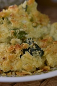 a close up of a plate of food with broccoli and cheese on it