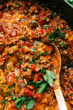 a skillet filled with meat and vegetables