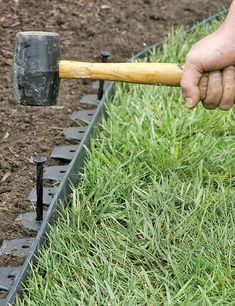 a man is digging in the ground with an axuet and some dirt on it