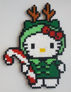 a hello kitty christmas ornament hanging on a wall