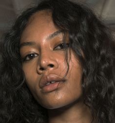 a close up of a woman with curly hair