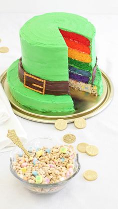 a cake with a slice missing from it on a platter next to some gold coins