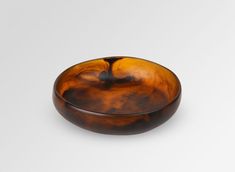 a brown bowl sitting on top of a white table