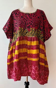 Artisan Kantha Bae Quilt Mini Dress. Dress falls just above the knee. With a high low hem, the dress is perfect for all ages. Soft, and Very Chic. An absolute favorite in daytime dresses. Why do we love it? Our best selling dress has been the midi version. Now... the shorter mini has been created. Now a best seller, surpassing the midi. This dress is a perfect example of maximizing the use of mixed prints to achieve a sophisticated fashion statement.The style is fresh, mixed prints engineered cr Flowy Patchwork Short Sleeve Dress, Free Size Short Sleeve Batik Print Dress, Bohemian Short Sleeve Patchwork Dress, Beach Dresses With Patchwork And Short Sleeves, Lagenlook Tunic Dress For Festivals, Festival Lagenlook Tunic Dress, Red Lagenlook Summer Dress, Festival Batik Print Short Sleeve Dress, Festival Dresses With Batik Print And Short Sleeves