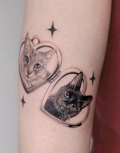 a cat and a kitten in a heart tattoo on the left arm with stars around it